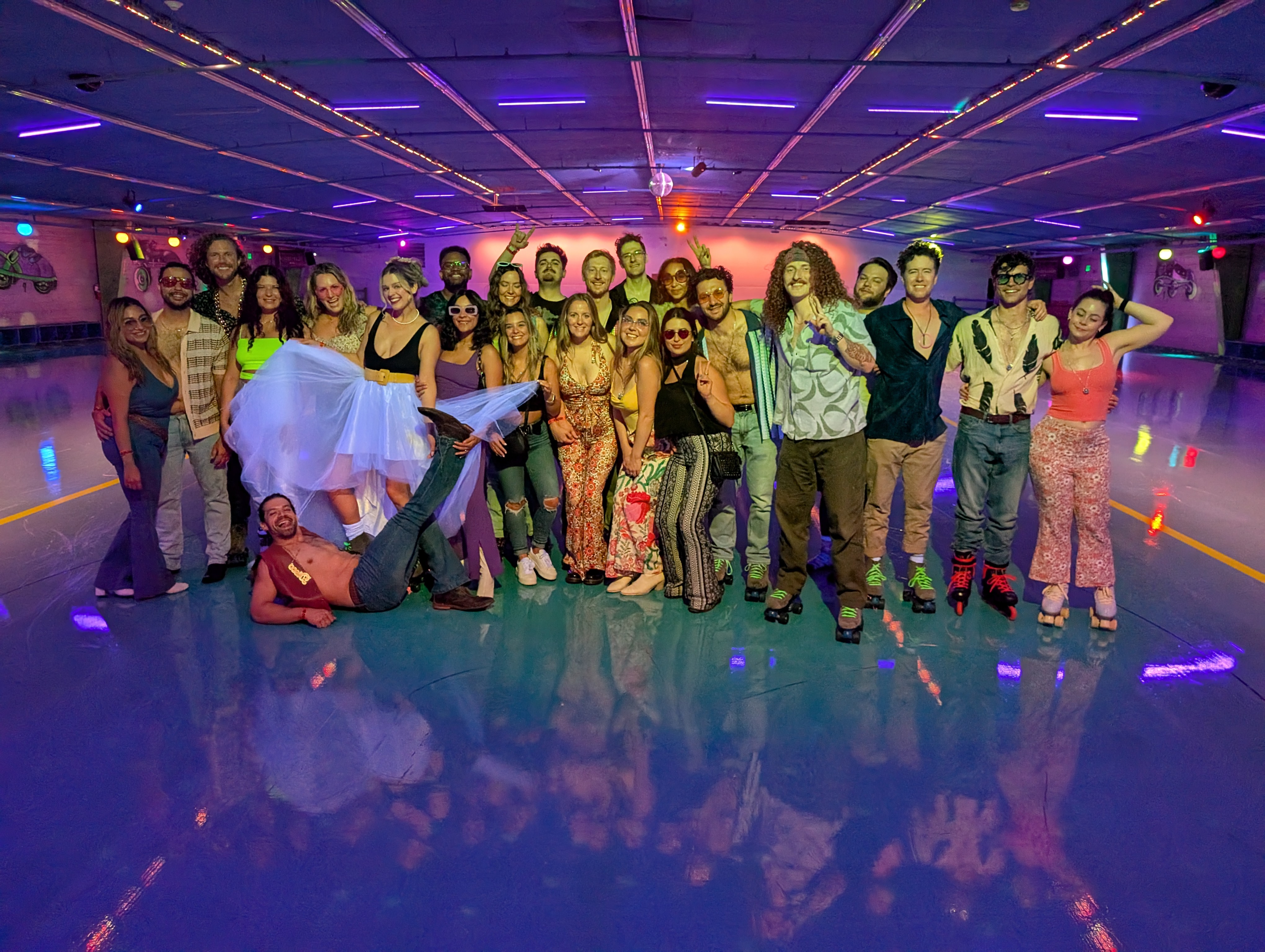 DJ EnSueño at a themed roller rink event with large group